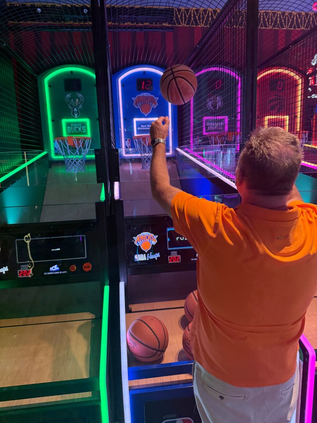 Man shooting hoops at arcade
